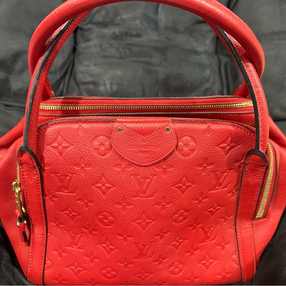 Louis Vuitton Red Monogram Empreinte Leather purse with zipper compartments.